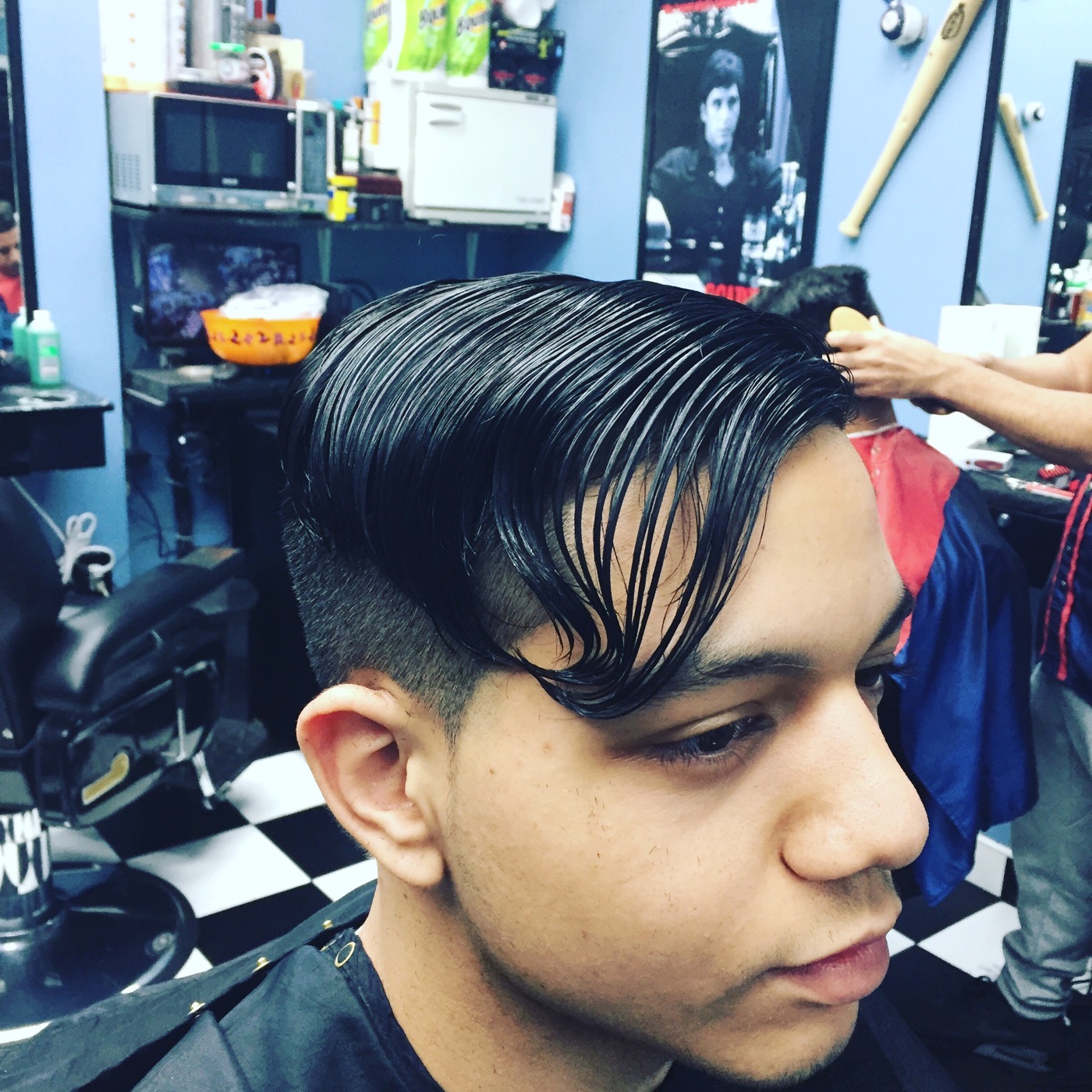 Slicked-back cut with an undercut at Sunset All Stars